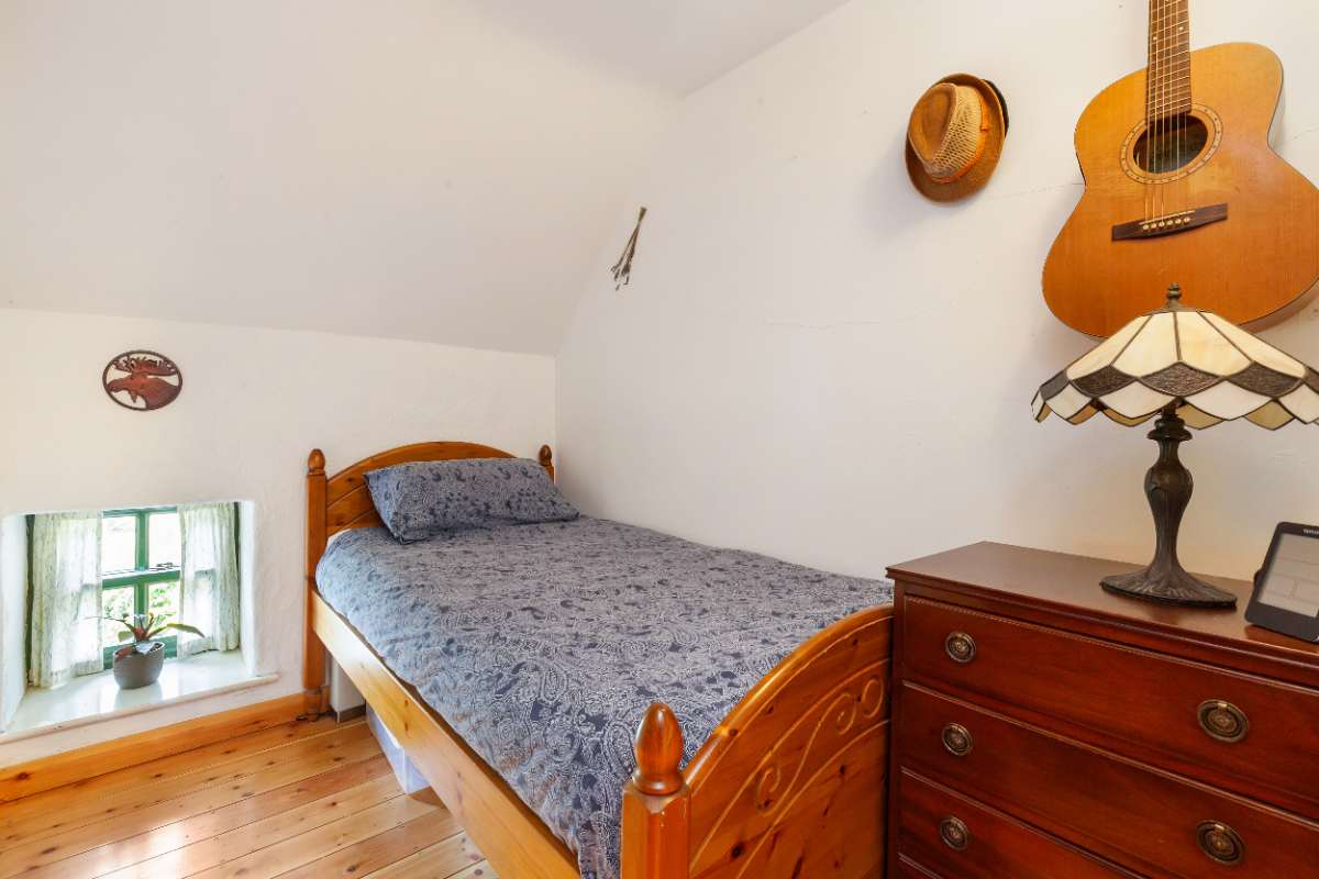 Second bedroom with deep-set window under the eaves