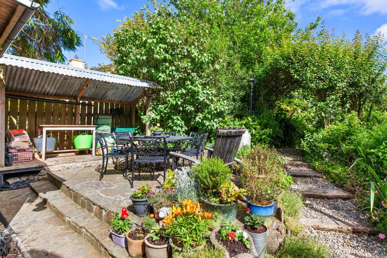 Paved garden terrace with outdoor dining